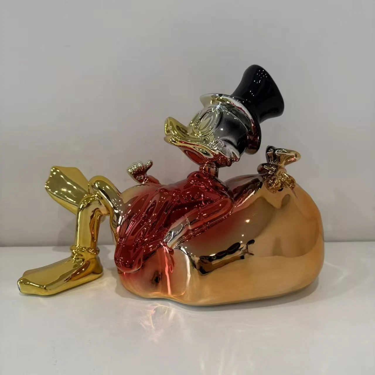 Metallic seated character display sculpture